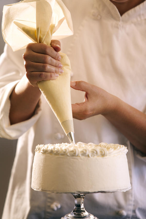 Chef decorating cake #1 Photograph by Thinkstock Images