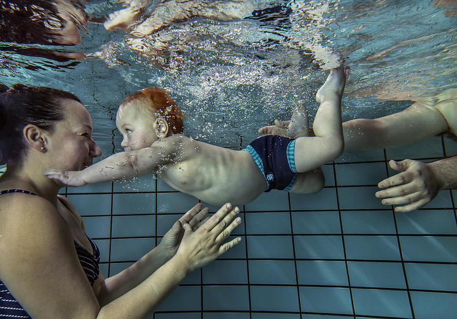 Child learning to swim. #1 Photograph by David Trood
