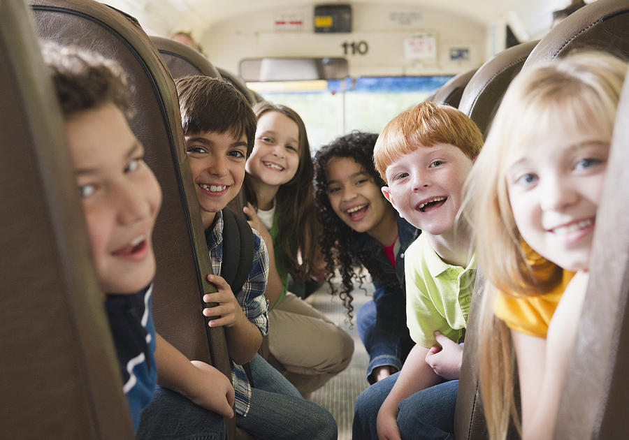 Children riding school bus #1 Photograph by Blend Images - JGI/Jamie Grill