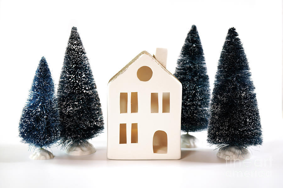 Christmas holiday background with white village house and tree ornaments. #1 Photograph by Milleflore Images