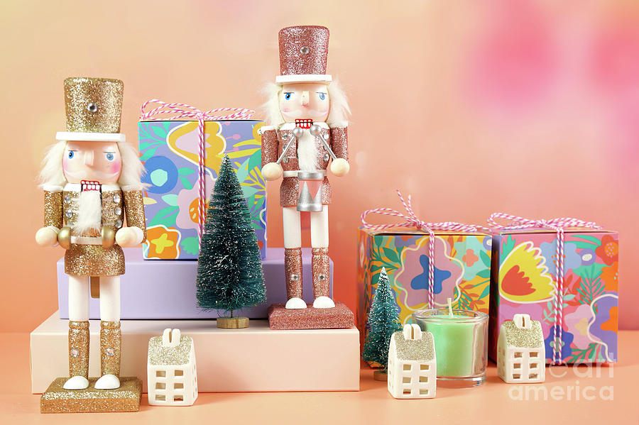 Christmas nutcracker ornaments and gifts against a modern coral background. #1 Photograph by Milleflore Images