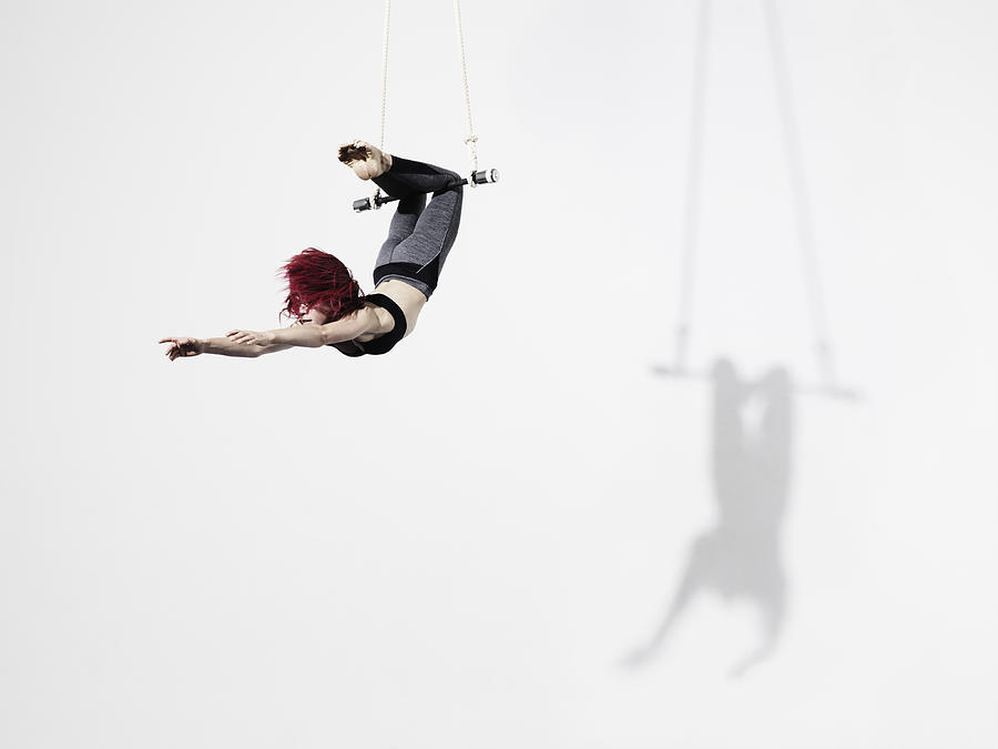 Circus artist in Trapeze #1 Photograph by Henrik Sorensen