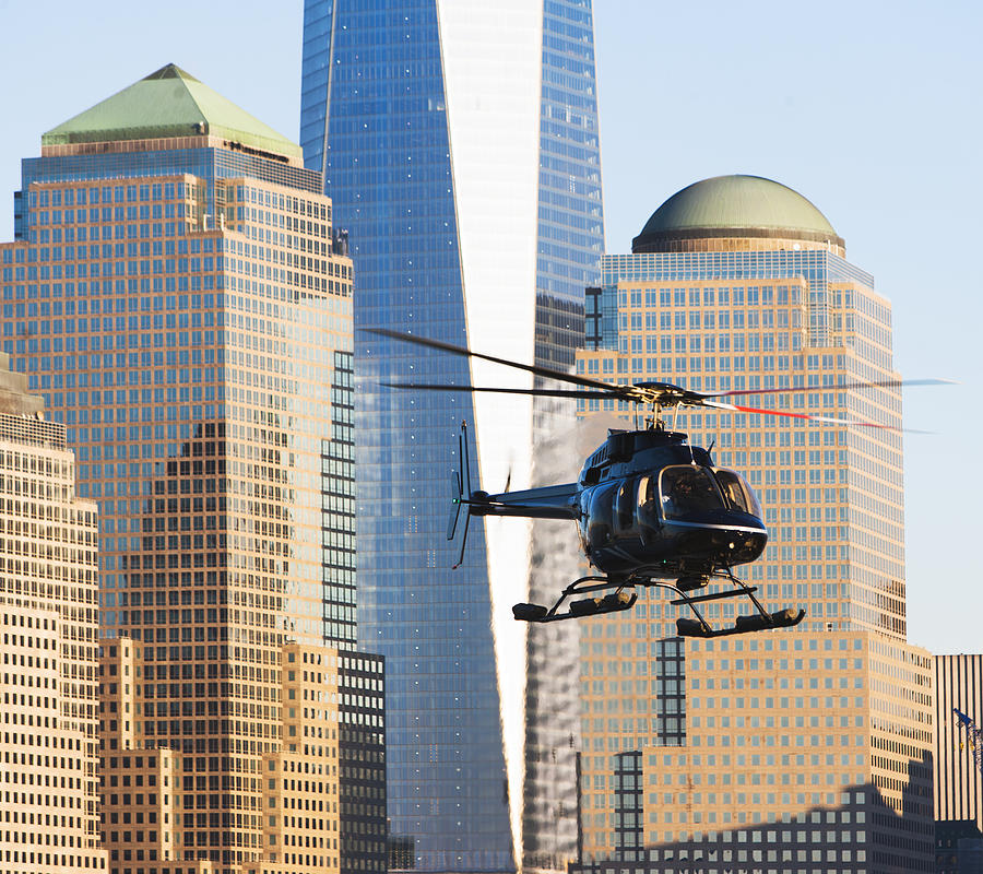 Close up of helicopter and office buildings, New York, USA #1 Photograph by Ditto