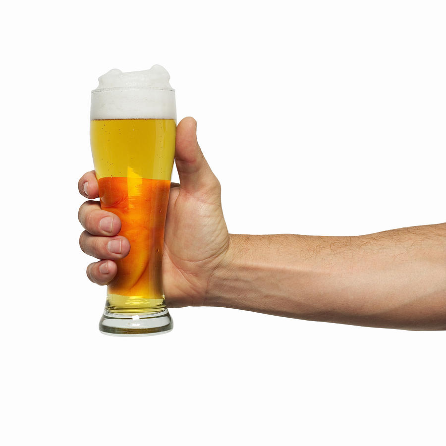 Close-up of mans hand holding glass of beer #1 Photograph by George Doyle
