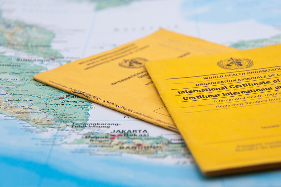 Close Up of Vaccination Certificate and world map. #1 Photograph by Nodramallama