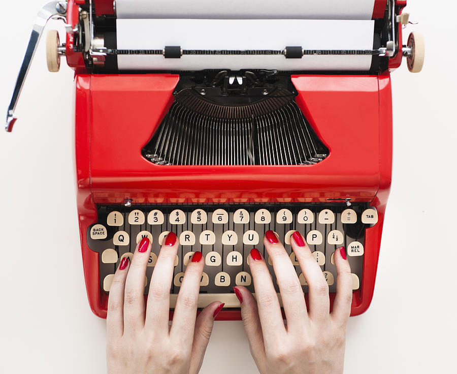 Close up of womans hands with red nail polish typing on antique typewriter #1 Photograph by Tetra Images