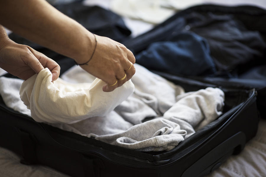 Closeup of Womans hands packing suitcase #1 Photograph by Robin Skjoldborg