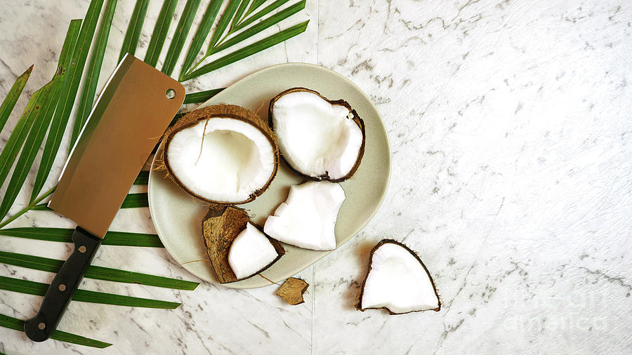 Nature Photograph - Coconut cut into pieces on plate on marble table top, creative flat lay. #1 by Milleflore Images