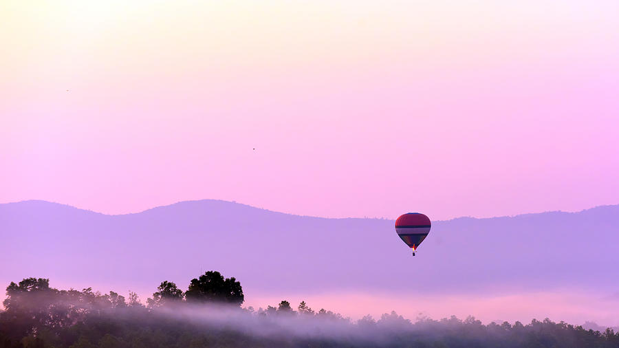 Colorful hot air balloon on sunrise sky over mountain . #1 Photograph by Sarote Pruksachat