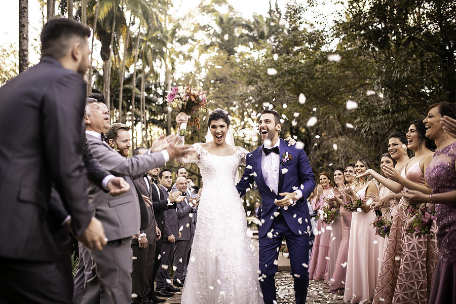 Confetti throwing on happy newlywed couple #1 Photograph by FG Trade