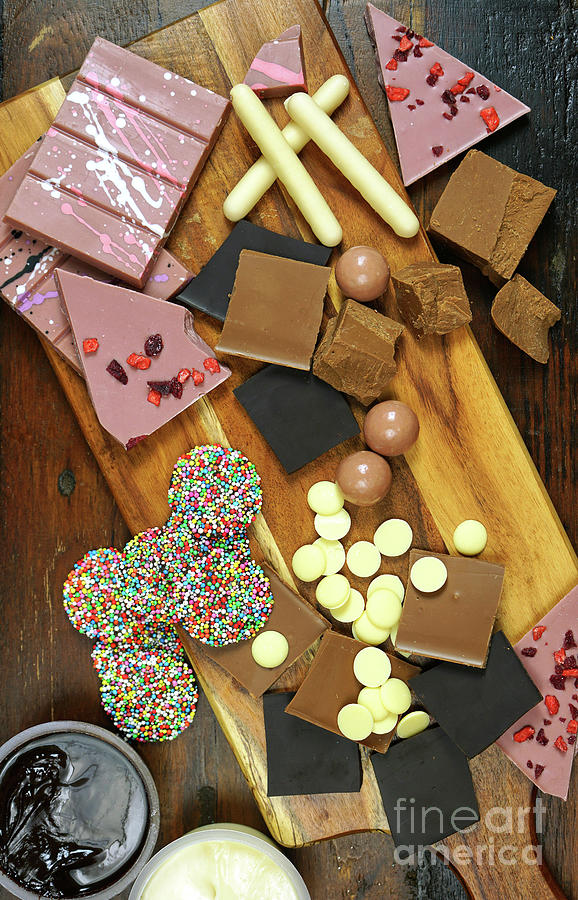 Chocolate, grater and grated chocolate on a chopping board Stock