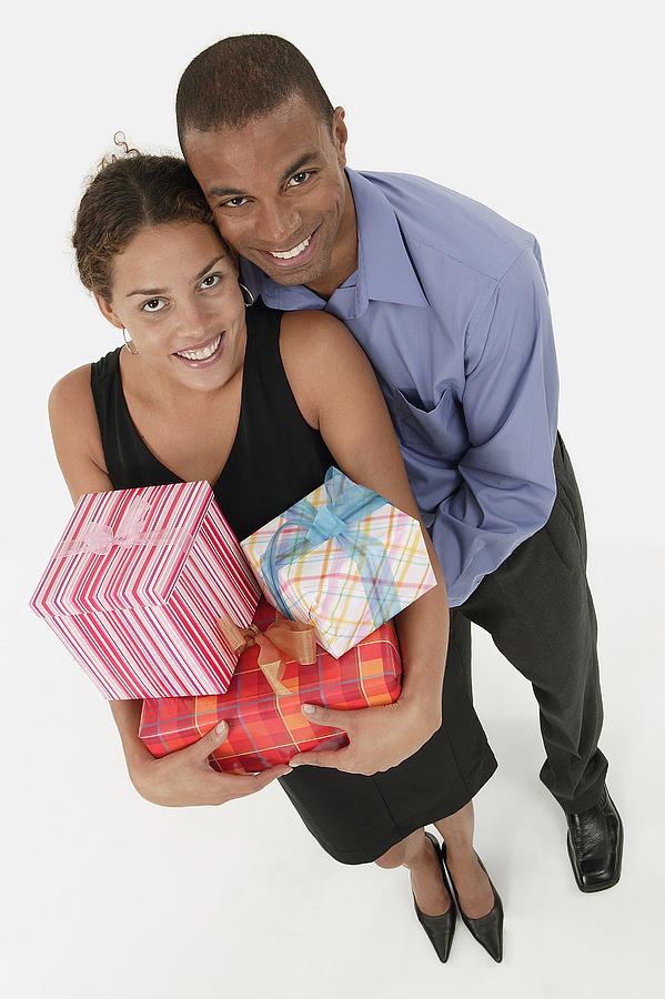 Couple holding gifts #1 Photograph by Comstock Images