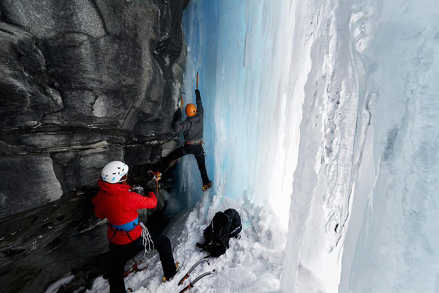 Couple in cave ice climbing, Saas Fee, Switzerland #1 Photograph by Adie Bush