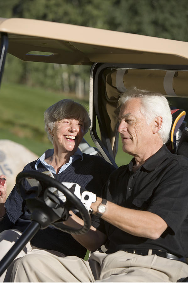 Couple in golf cart #1 Photograph by Comstock Images