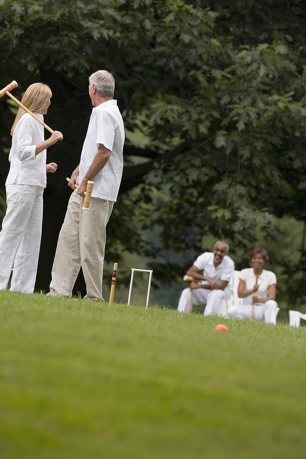 Couple playing croquet #1 Photograph by Comstock Images