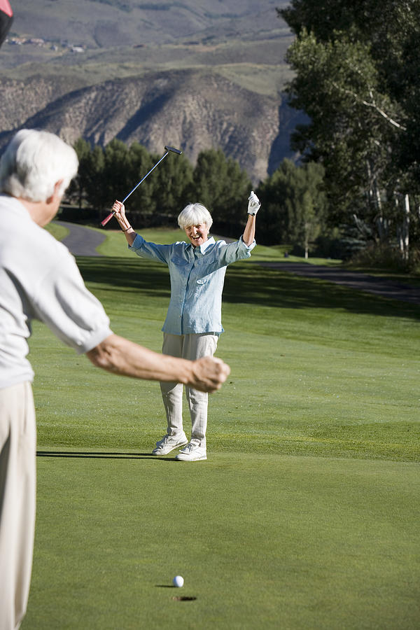 Couple playing golf #1 Photograph by Comstock Images