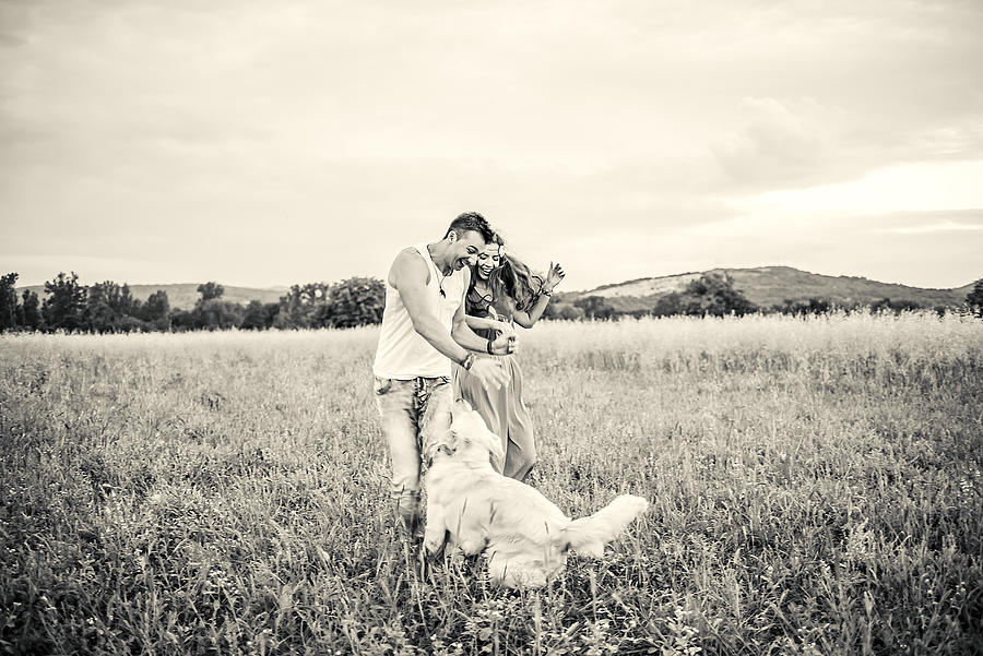 Couple with dog in nature #1 Photograph by MilosStankovic