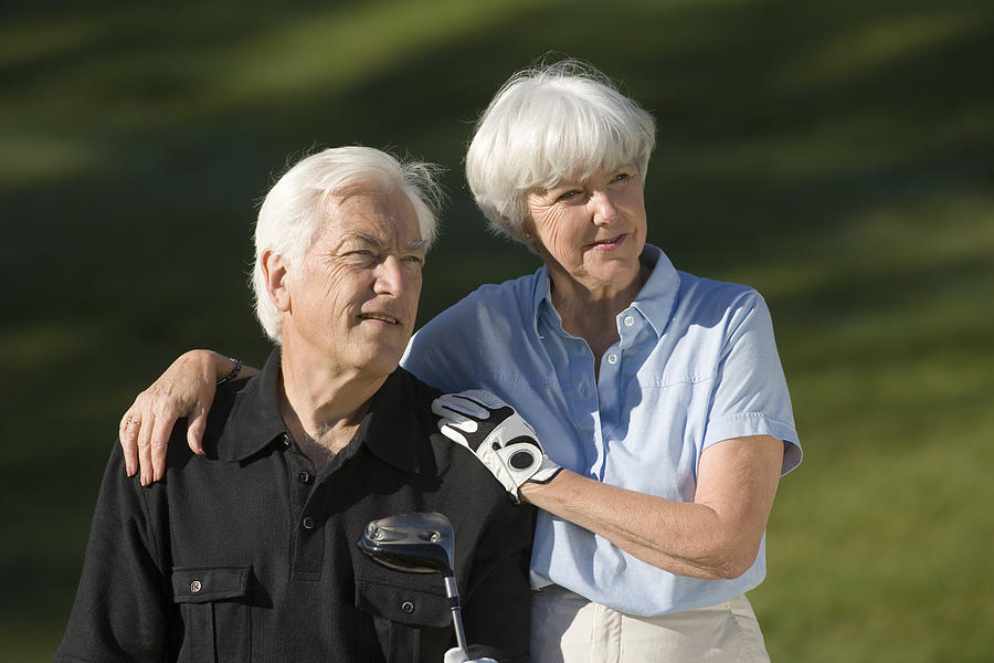 Couple with golf club #1 Photograph by Comstock Images