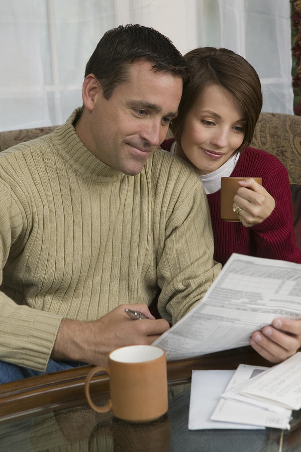 Couple with paperwork #1 Photograph by Comstock Images