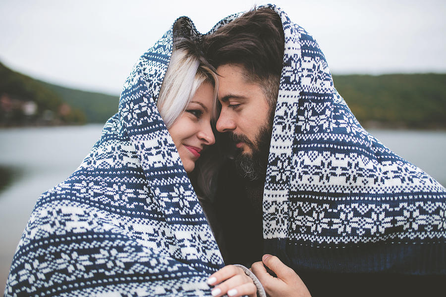 Couple wrapped in blanket #1 Photograph by Pekic