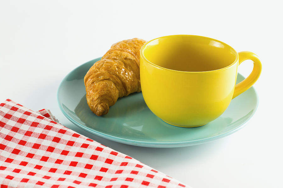 Croissant On Green Dish With Yellow Cup Coffee. #1 Photograph by Nanthaphiphat_Watto