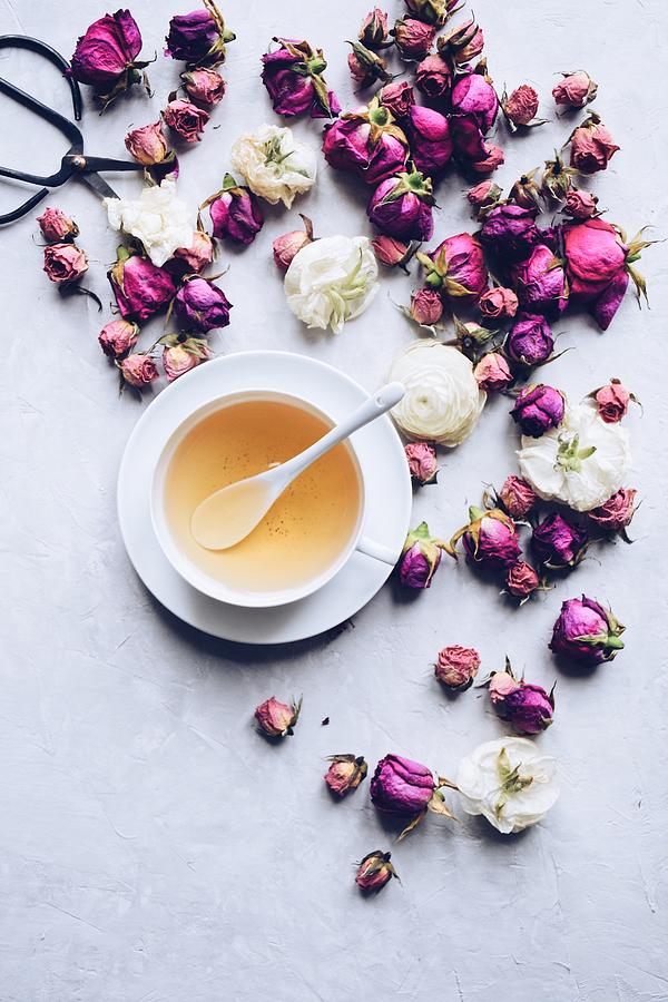 Cup of herbal tea with dried roses #1 Photograph by JuliaK