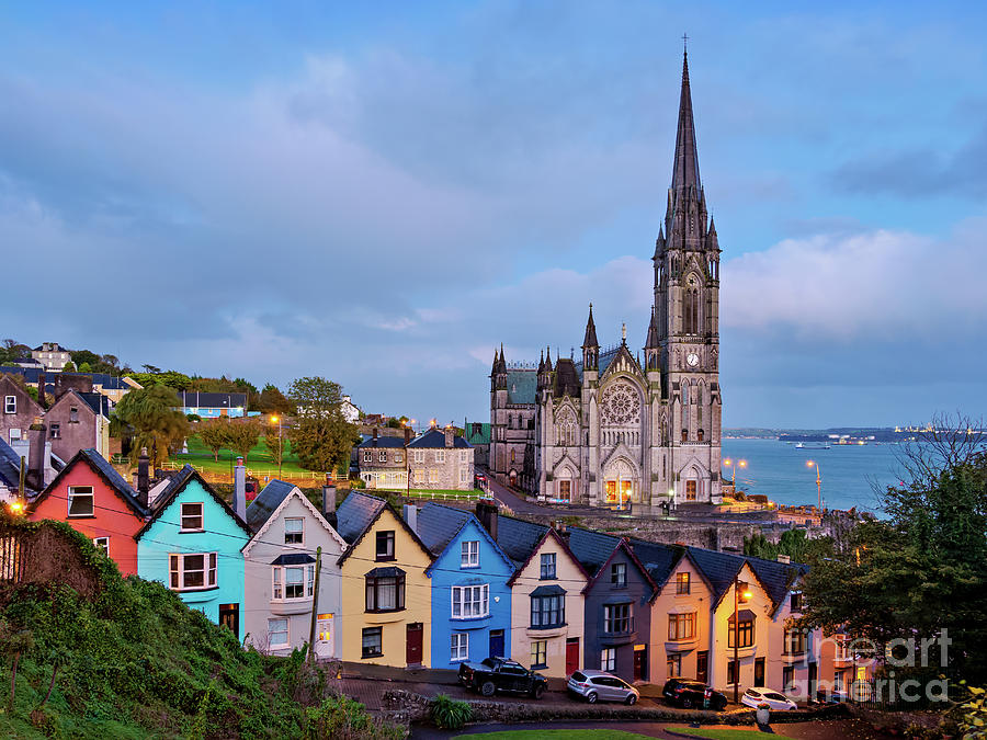 Deck of Cards colourful houses and St. Colman's Cathedral at dusk in ...