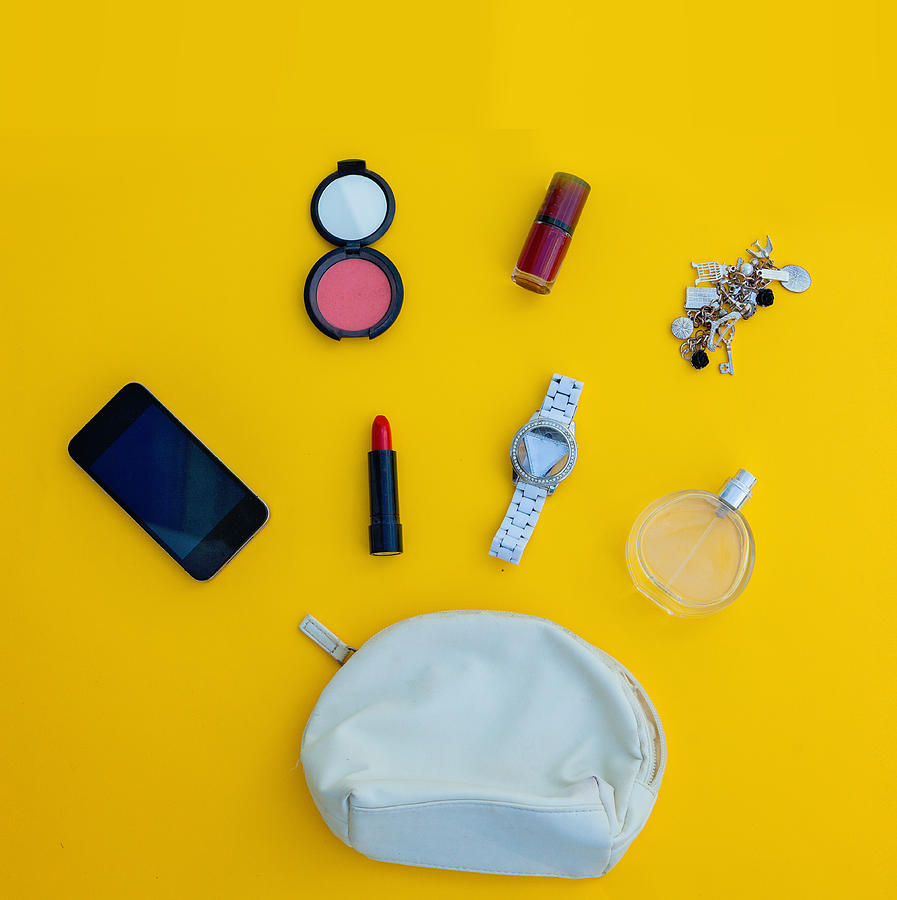 Dressing case with a lot of feminine objects.yellow background #1 Photograph by Carol Yepes