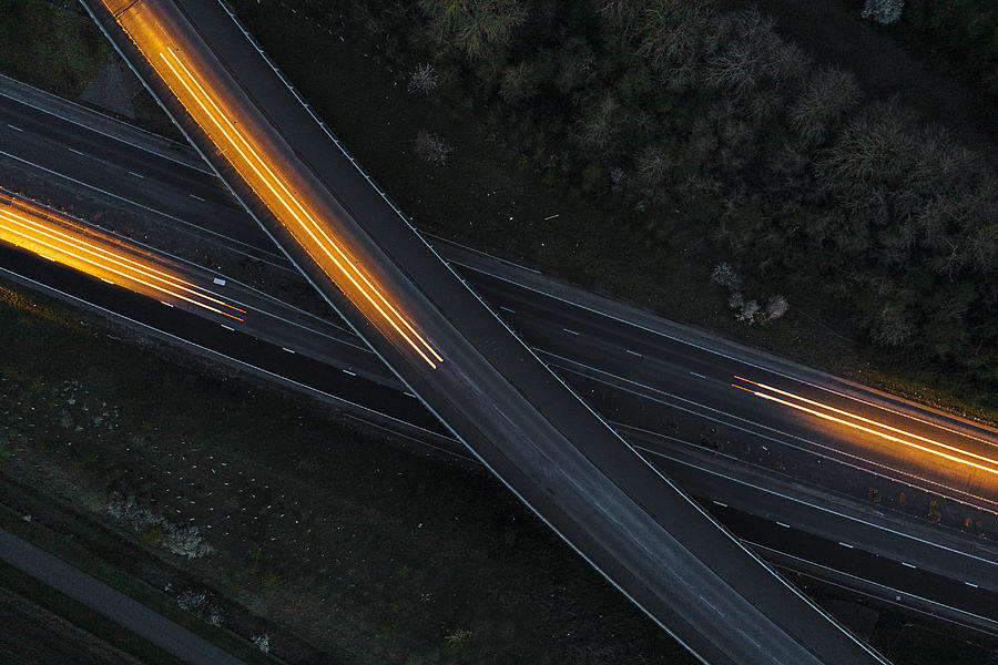 Drone view of cars moving in different directions at night #1 Photograph by Justin Paget