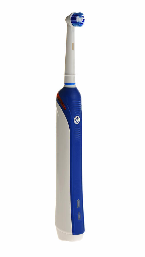 Electric toothbrush on a white background #1 Photograph by Gilbert Laurie