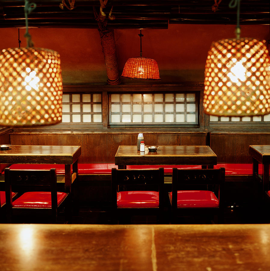 Empty tables and chairs in Japanese restaurant #1 Photograph by Ryan McVay