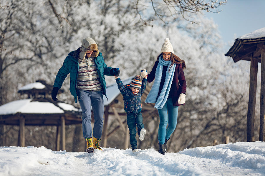 Family enjoying winter walk in the forest. #1 Photograph by EmirMemedovski