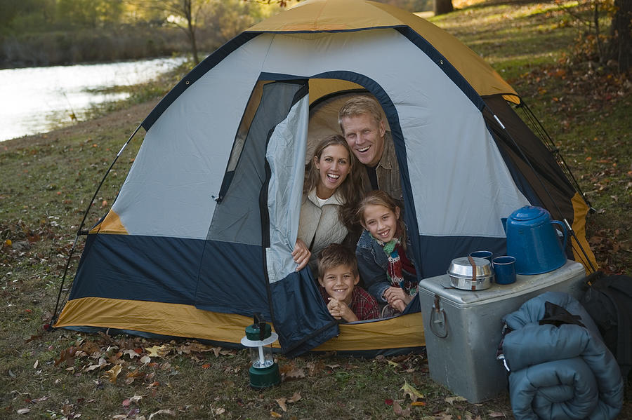 Family sitting in tent #1 Photograph by Comstock Images