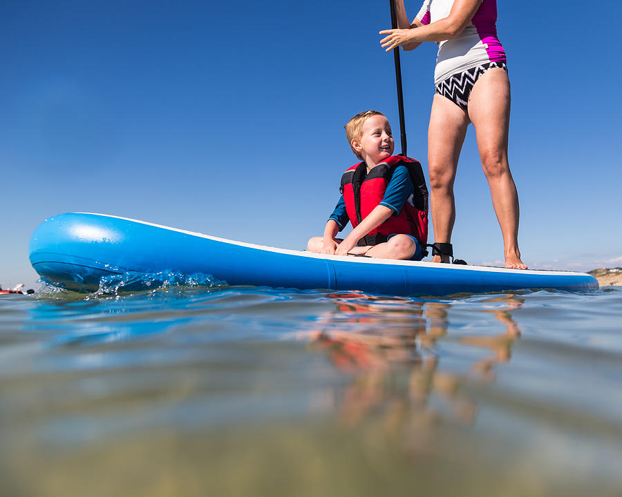 Family Stand Up Paddleboarding on the Isle of Wight. #1 Photograph by s0ulsurfing - Jason Swain