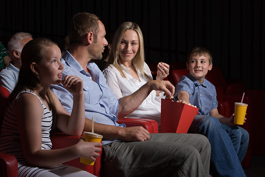 Family watching movie at the movie theater #1 Photograph by Image Source
