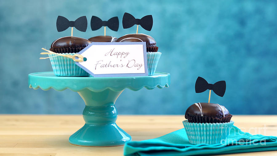 Fathers Day close up of chocolate cupcakes on cake stand on table. #1 Photograph by Milleflore Images