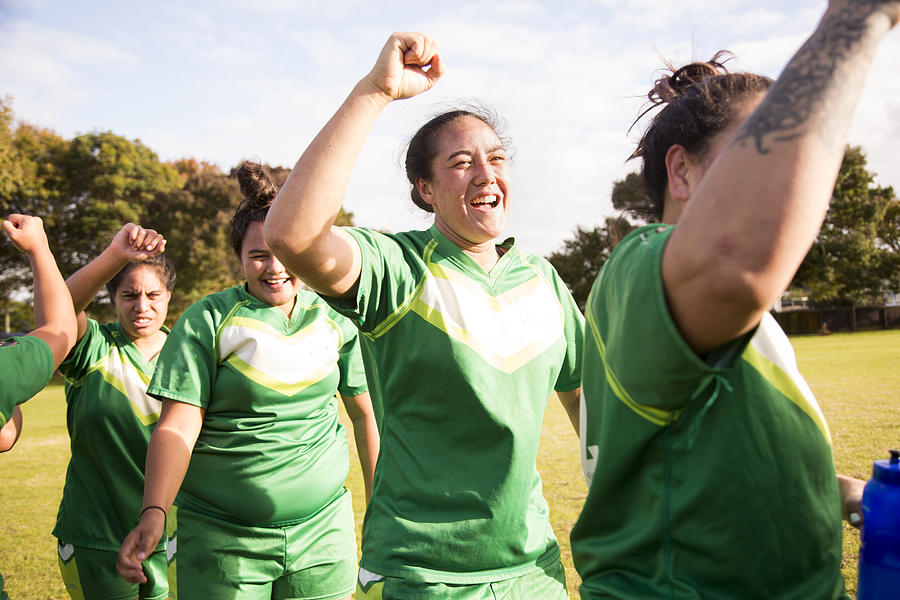 Female rugby players on field celebrating after match #1 Photograph by Jessie Casson
