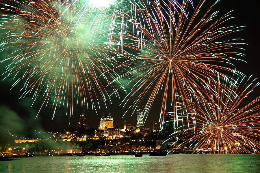 Fireworks display over city waterfront #1 Photograph by Jean Surprenant