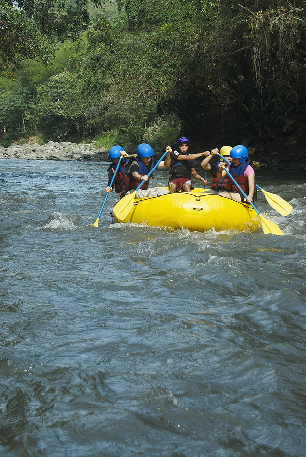 Five people rafting in a river #1 Photograph by Glowimages