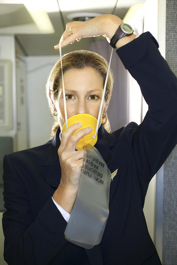 Flight attendant with an oxygen mask #1 Photograph by Thinkstock