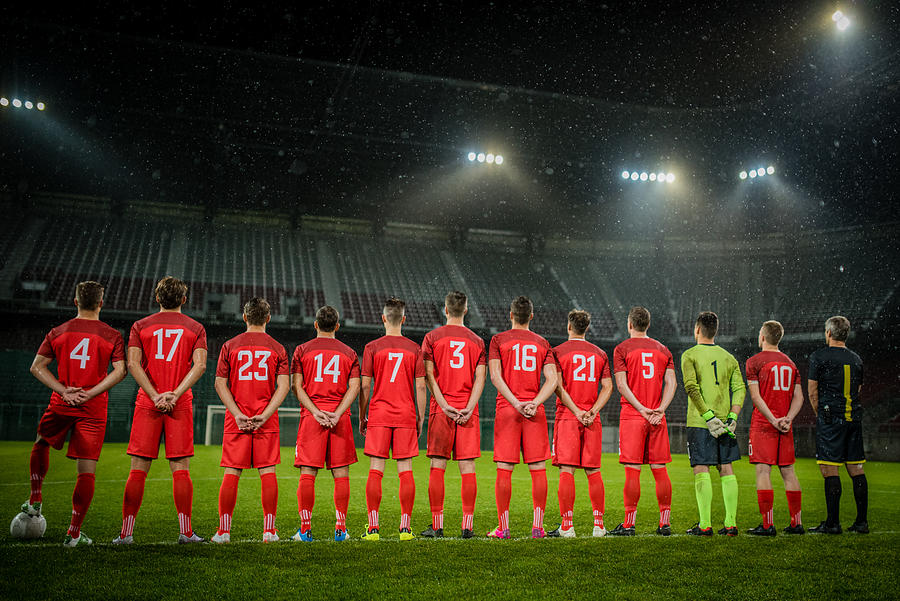 Football team in a row #1 Photograph by Simonkr