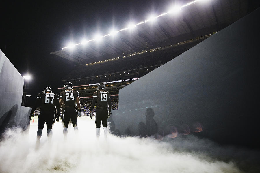 Football team walking out of stadium tunnel #1 Photograph by Thomas Barwick