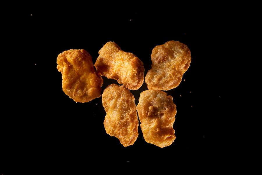 fried chicken Nuggets flying in mid air view from above #1 Photograph by Xvision