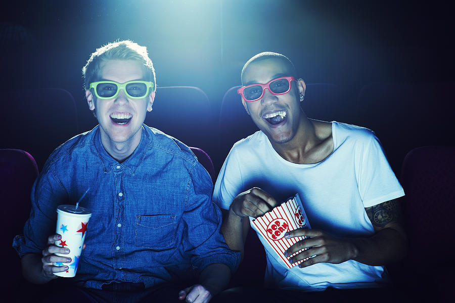 Friends at the cinema wearing 3D glasses #1 Photograph by Flashpop