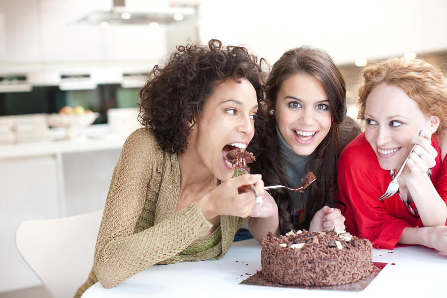 Friends eating chocolate cake #1 Photograph by Paul Bradbury