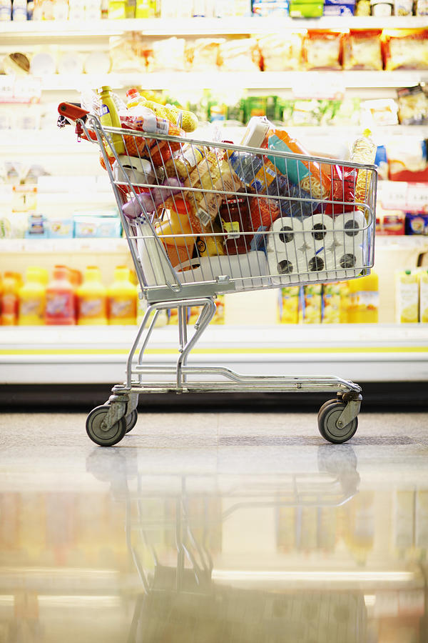 Full Shopping Cart in Grocery Store #1 Photograph by Fuse