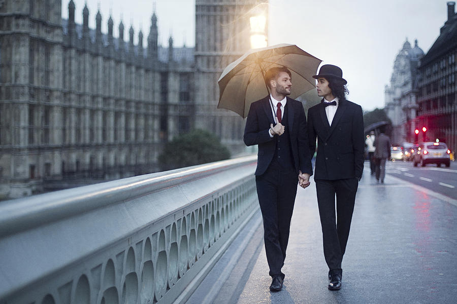 Gay couple walking in London rain. #1 Photograph by Photography by Braden Summers