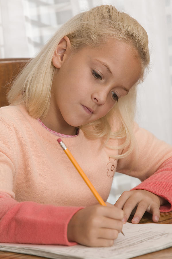 Girl doing homework #1 Photograph by Comstock Images