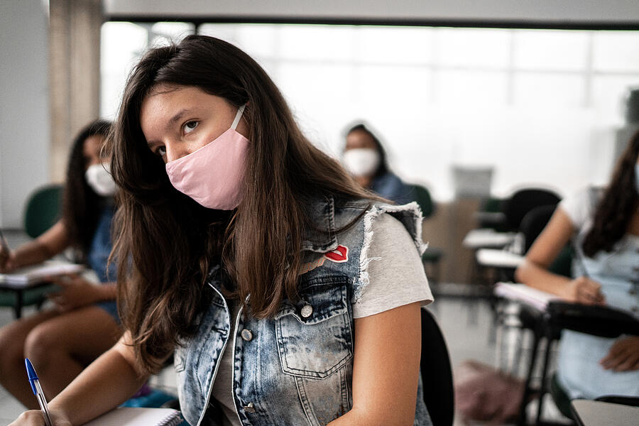 Girl studying at school - wearing protective face mask #1 Photograph by FG Trade