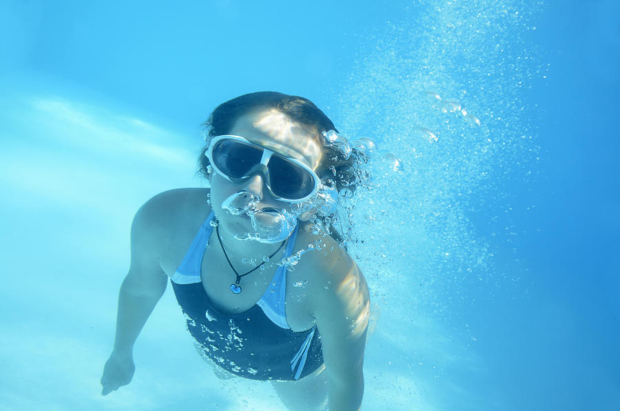 Girl swimming underwater in pool #1 Photograph by Sami Sarkis